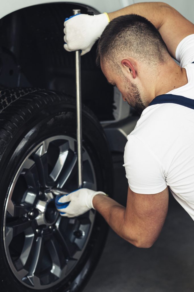 high angle male mechanic fixing car